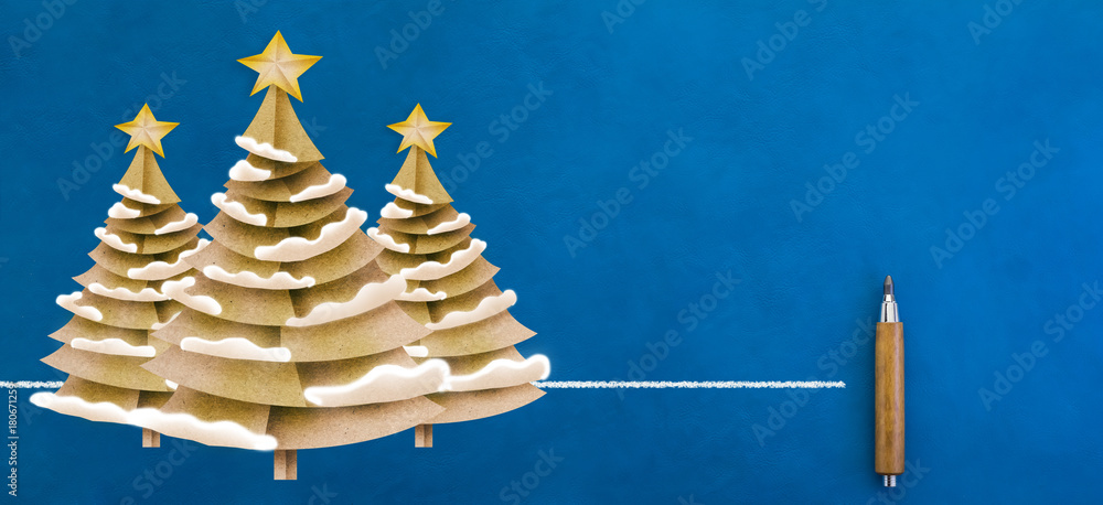 xmas tree paper cut on blue leather background with free copyspace xmas festive ideas card concept