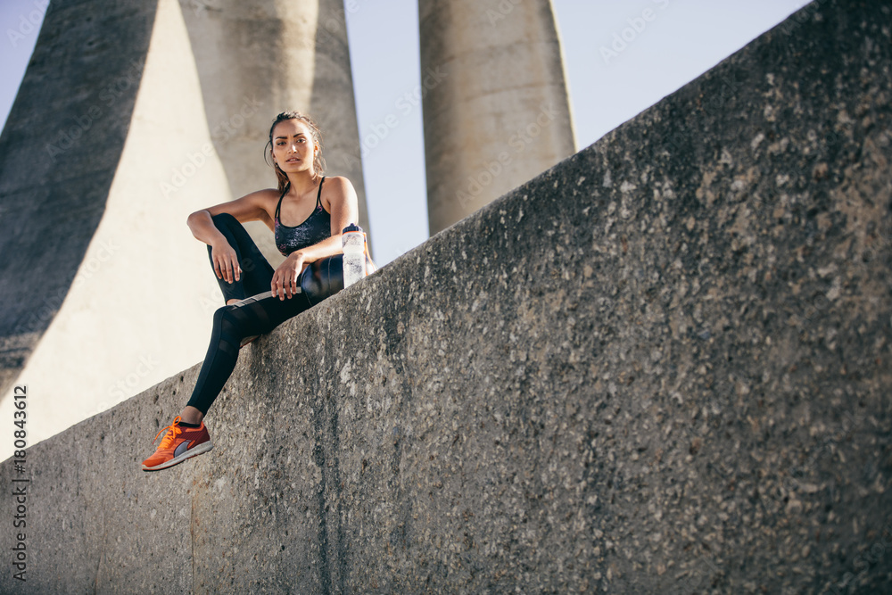 Sportswoman resting after physical training session