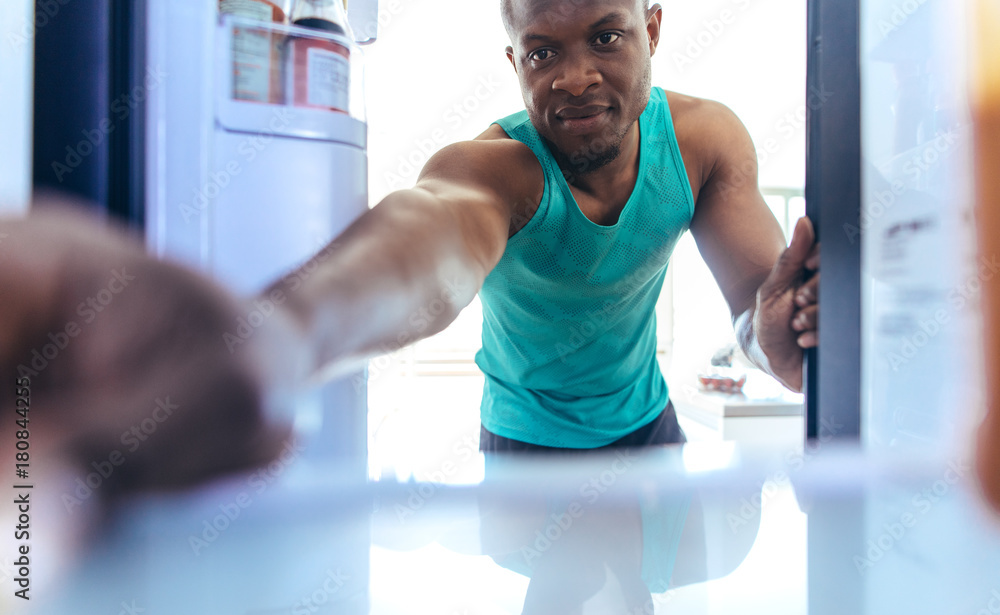 Man using refrigerator at home