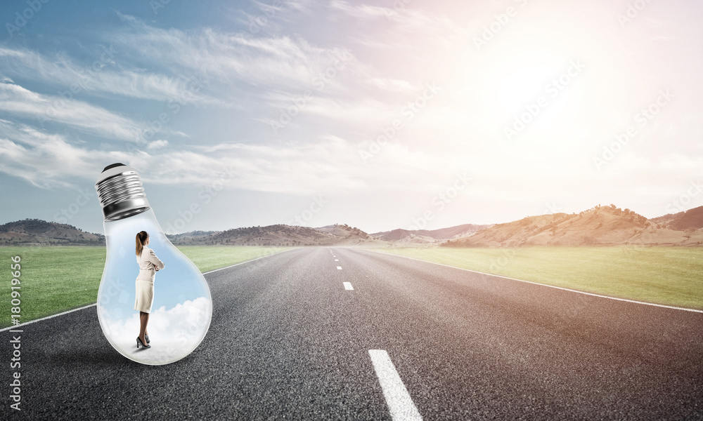 Businesswoman inside light bulb