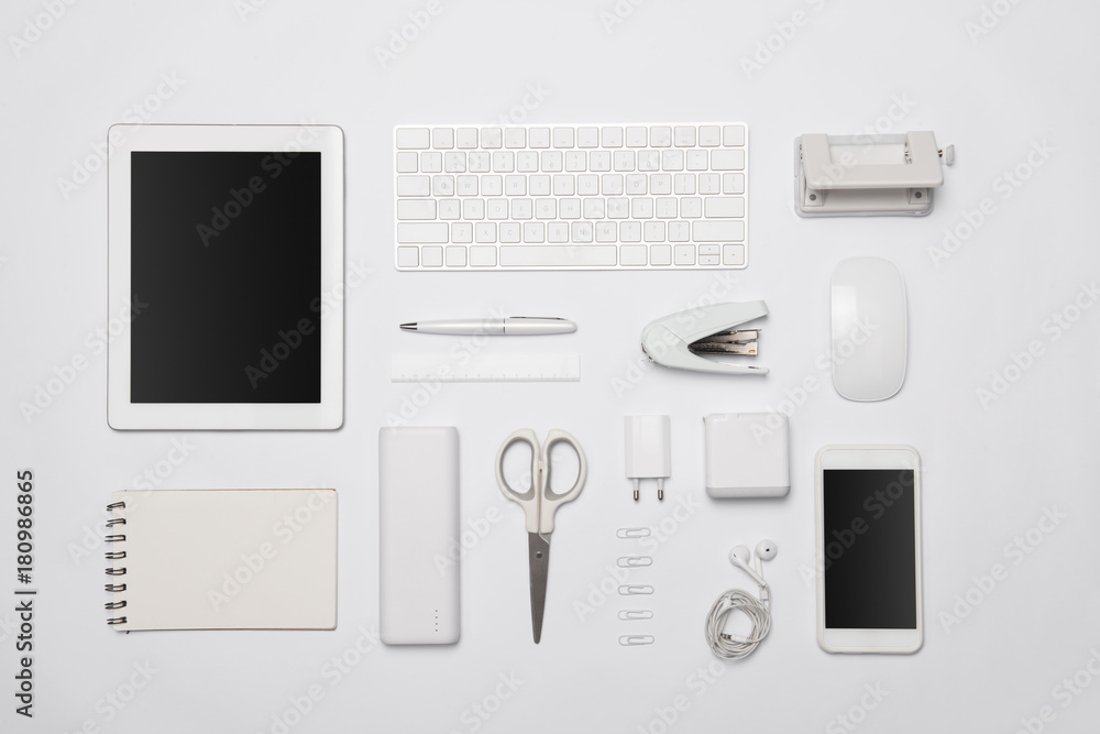 White office supplies. Digital tablet and smartphone on white table background with copy space.