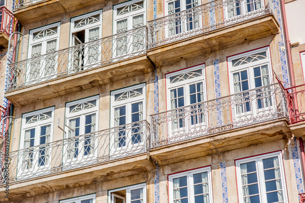 Street view on the beautiful old buildings with portuguese tiles on the facades in Porto city, Portu