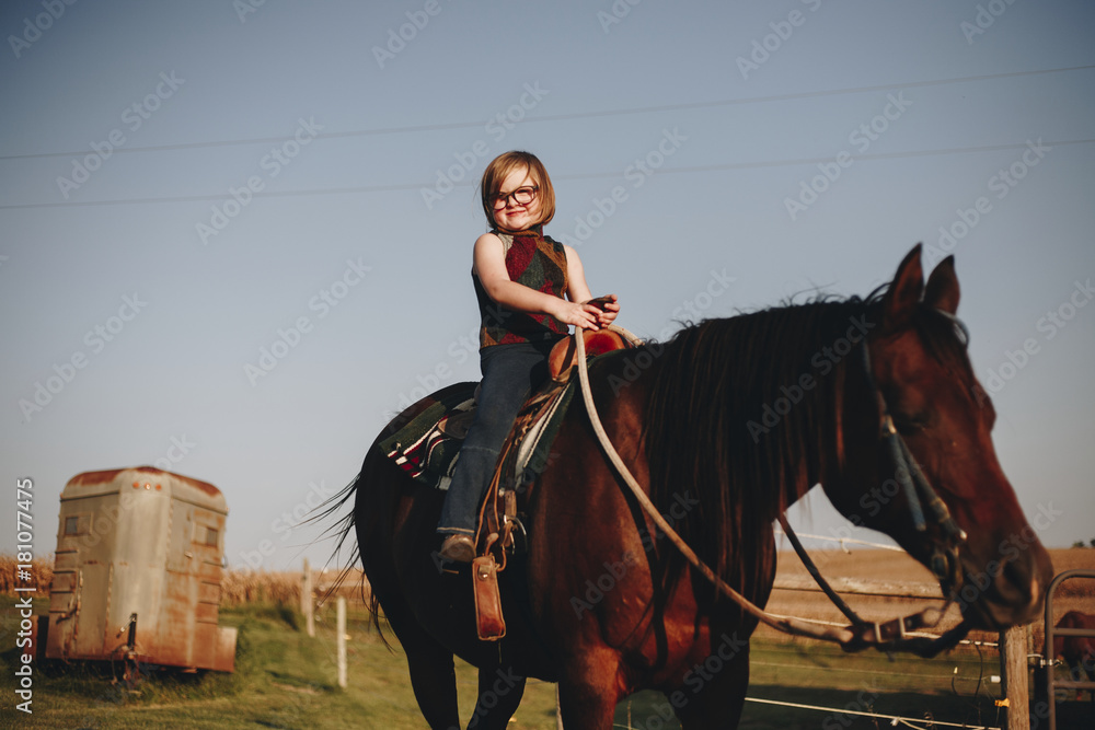 Young girl is enjoying a horse riding