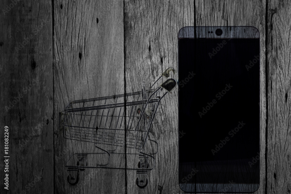 mobile phone and shopping cart on dark wood background,Online shopping concept