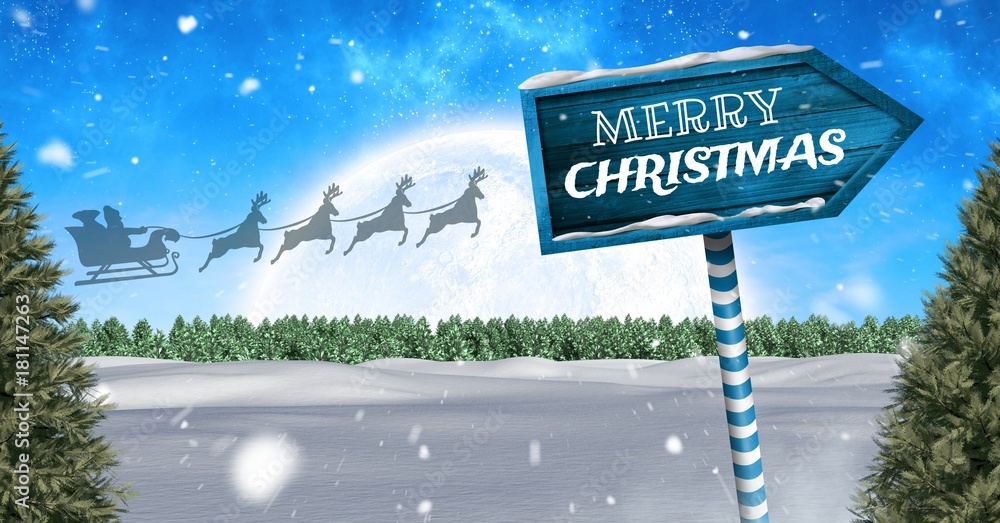 Merry Christmas text on Wooden signpost in Christmas Winter