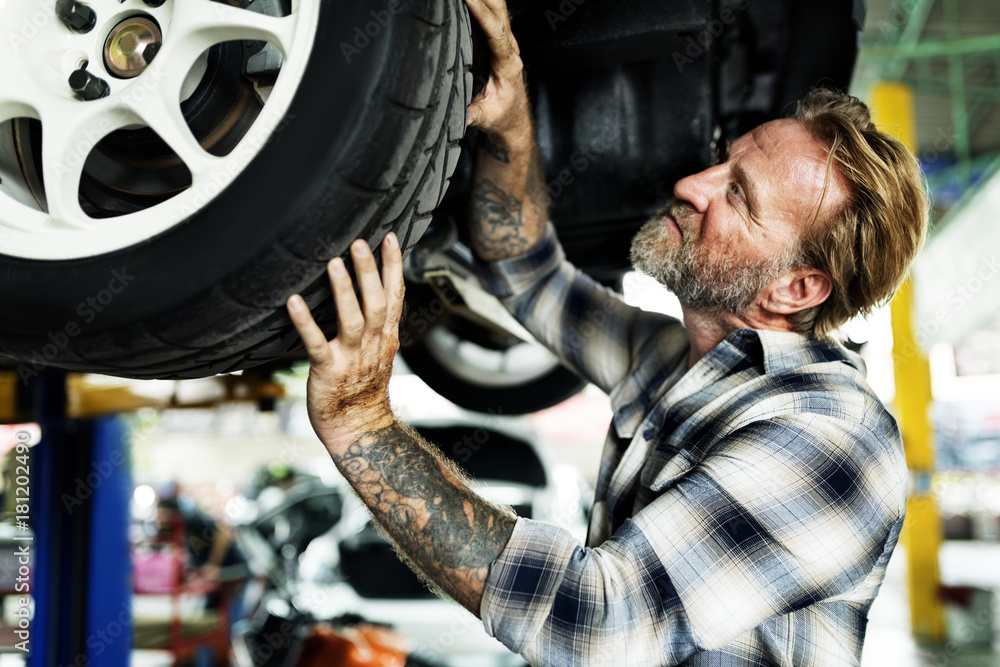 A mechanic fixing a car