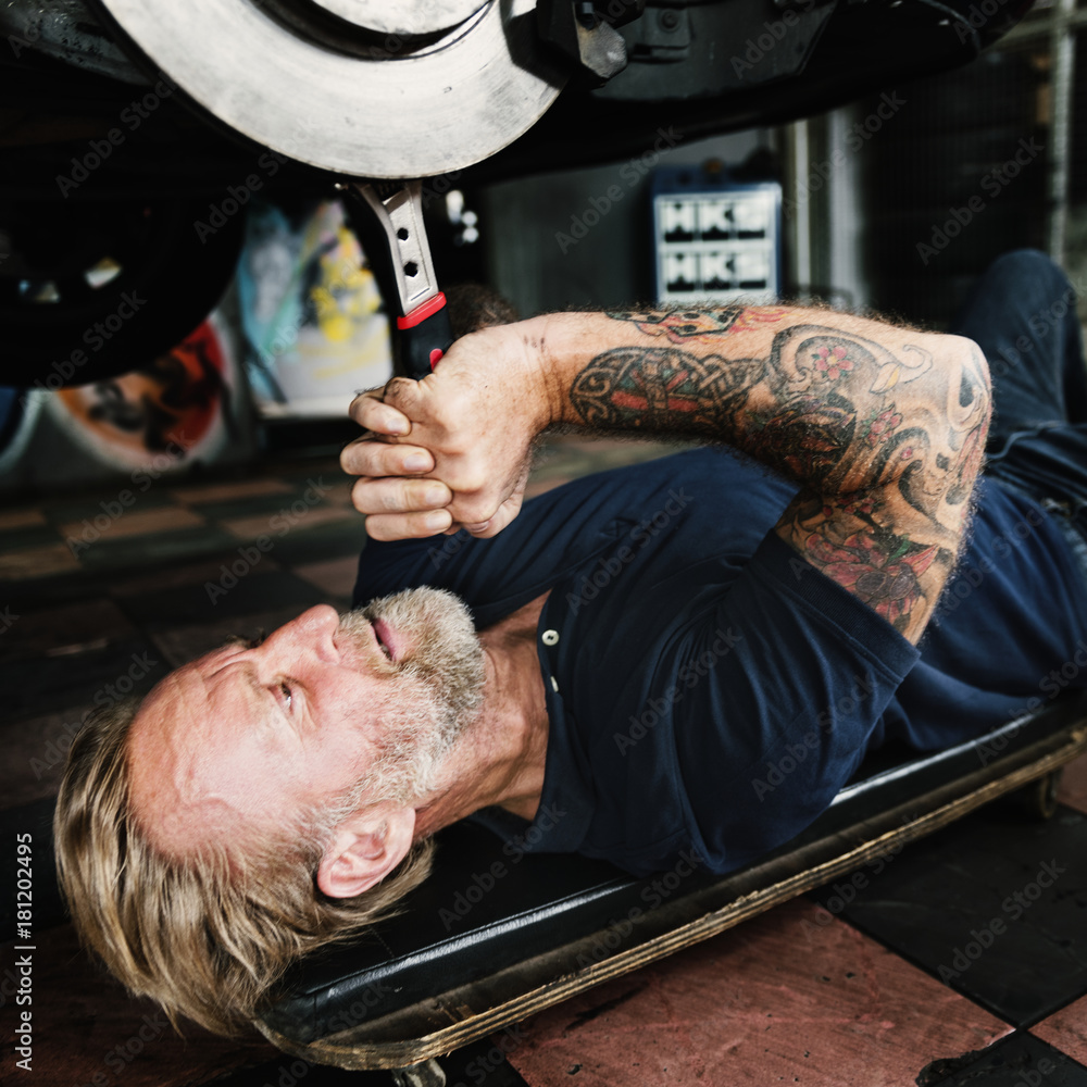 A mechanic fixing a car