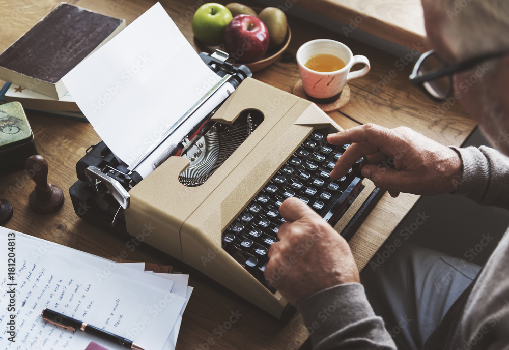 Old man typing on a typewriter