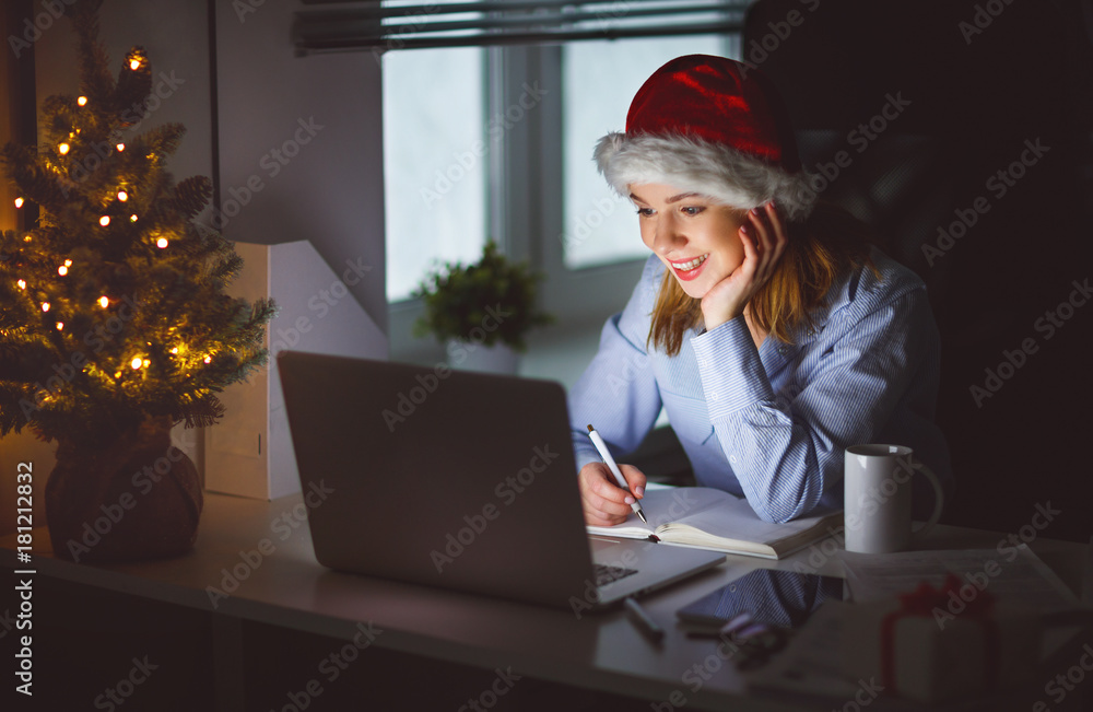 businesswoman freelancer tired, working at computer at Christmas night