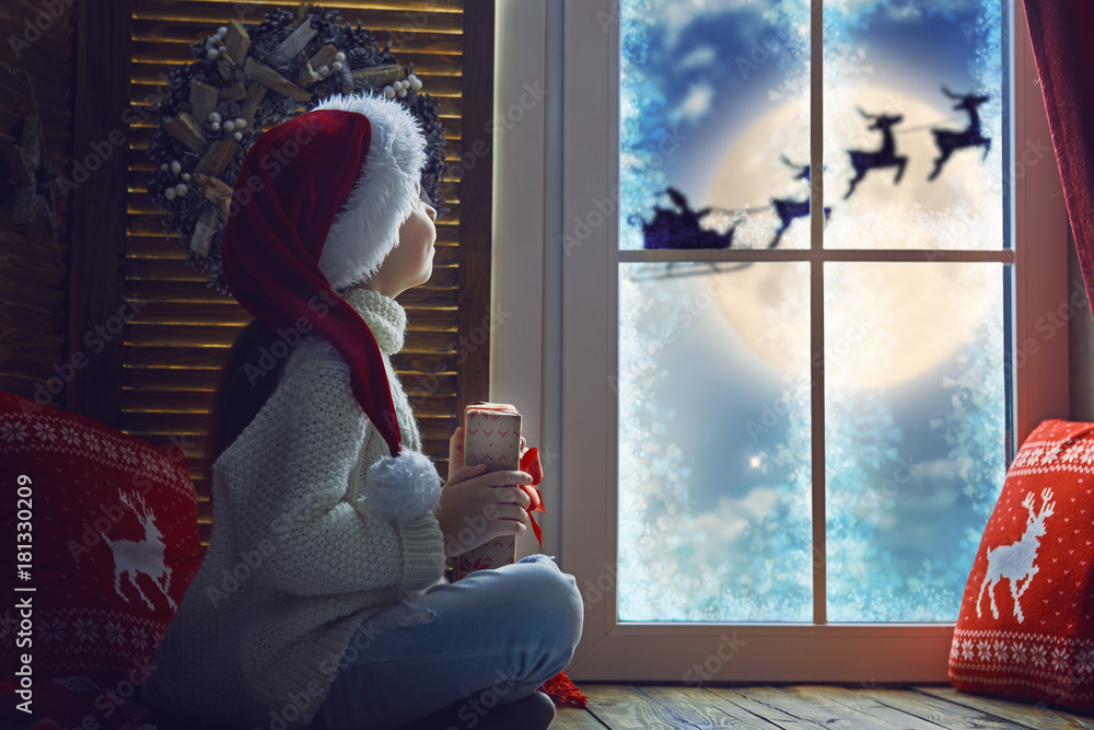 girl by window at Christmas