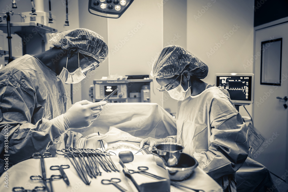 doctor and assistance Medical team performing surgery on a patient with focus and stressful moment