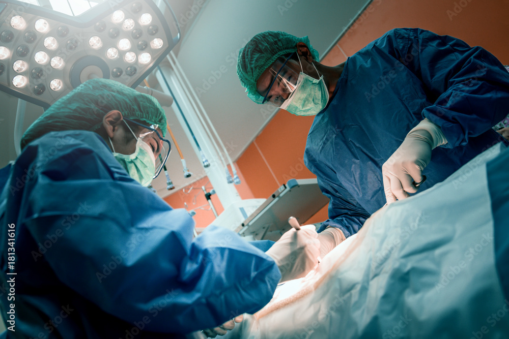 doctor and assistance Medical team performing surgery on a patient with focus and stressful moment