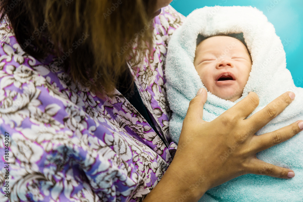 mother hold baby in her arm with love family concept