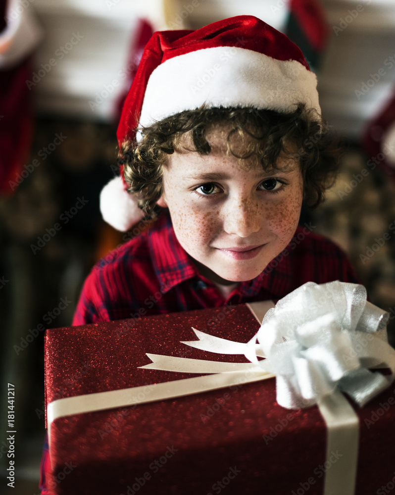 Young Caucasian boy with Christmas present box