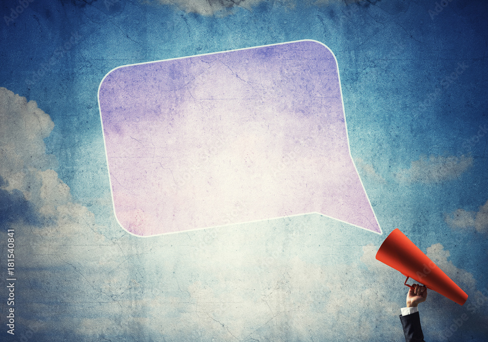 Hand of businesswoman holding red paper trumpet and speech cloud