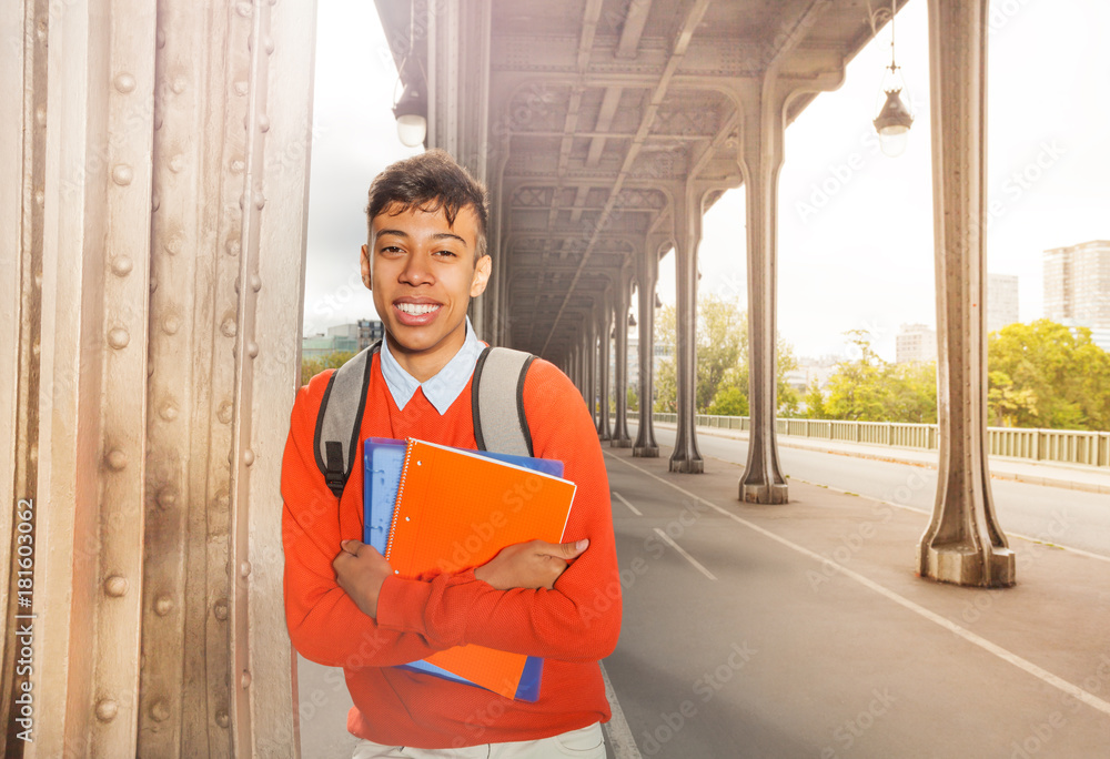 Student with textbook strolling on Paris streets