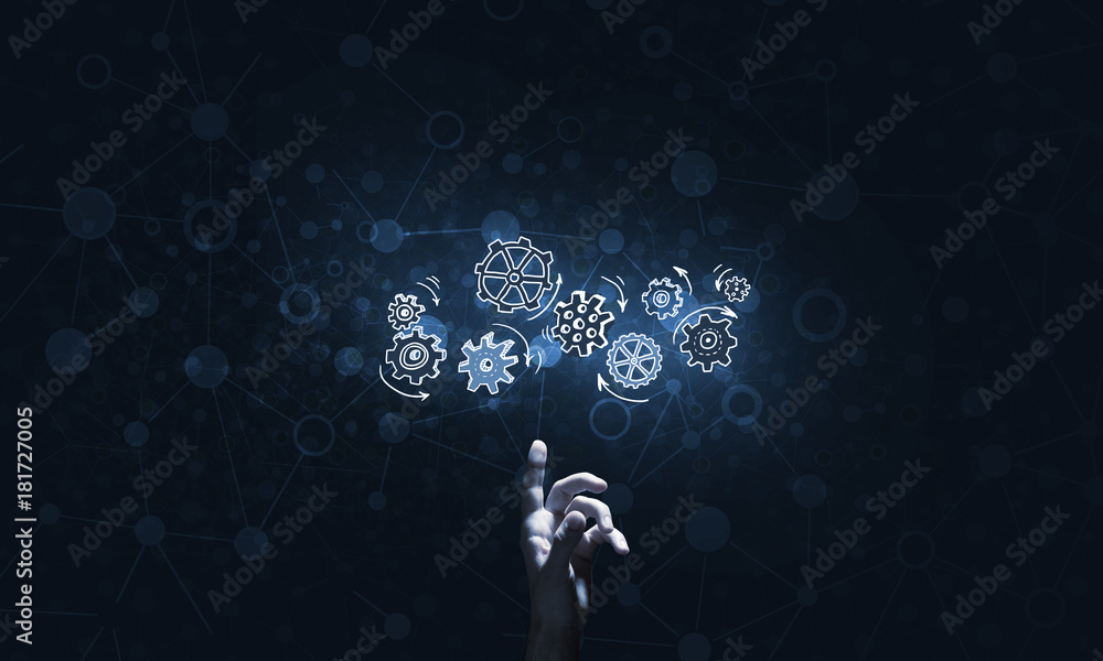 Glowing cogwheel mechanism icon on dark background as symbol of teamwork