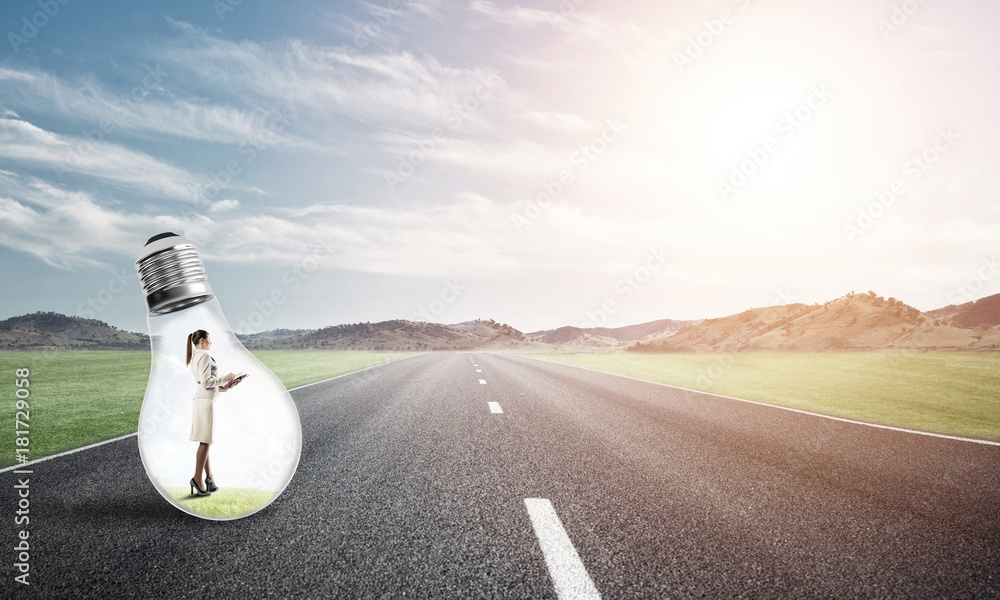 Businesswoman inside light bulb