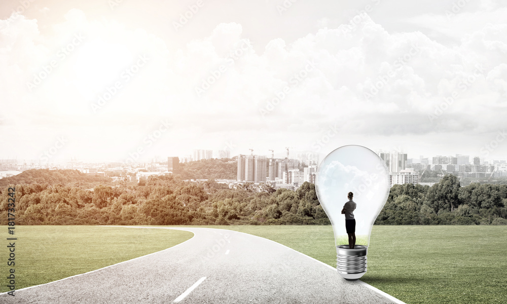 Businesswoman inside light bulb