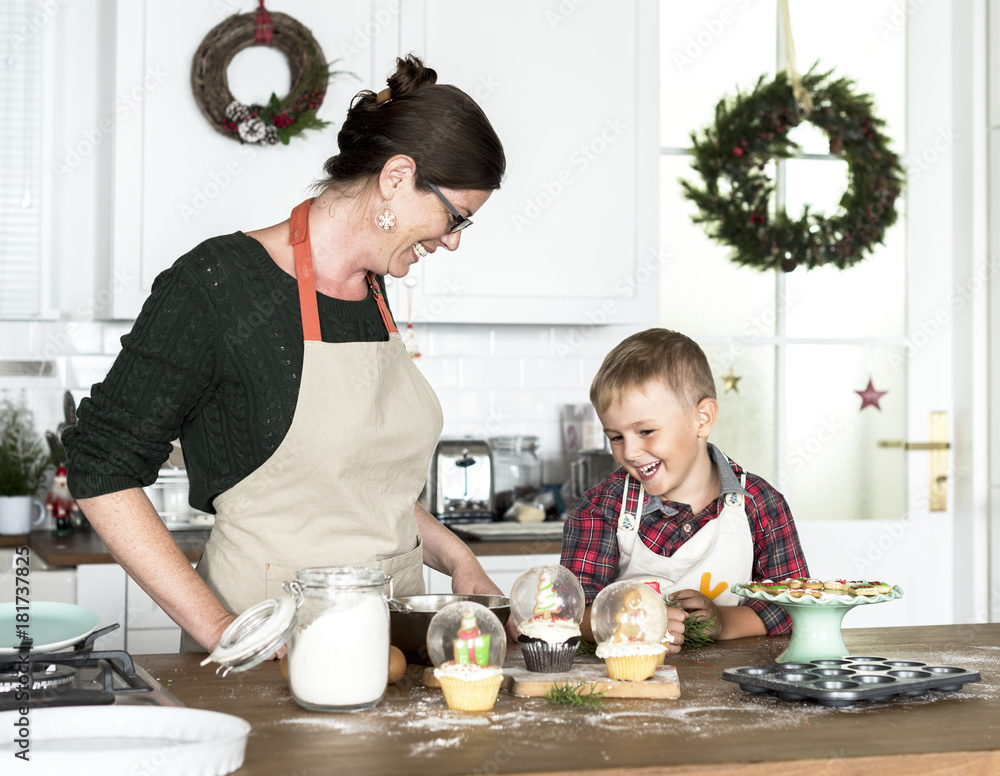 Mother and son baking for Christmas in the kitchen