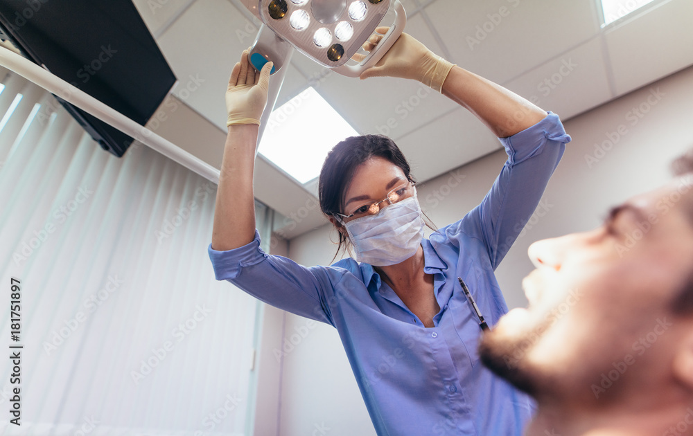 Dentist preparing for a dental treatment on patient