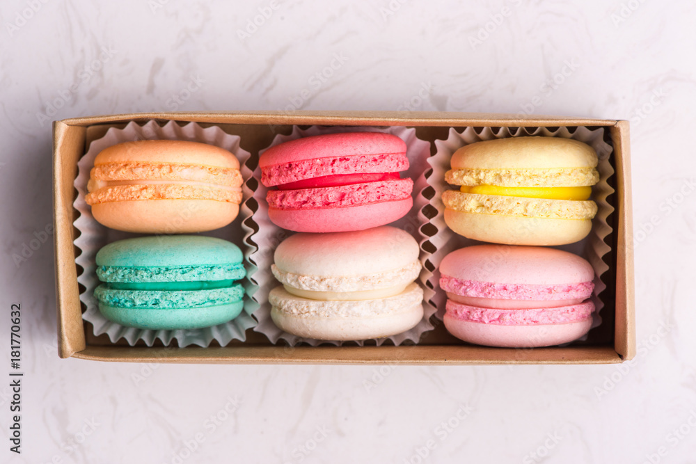 Set of different french cookies macaroons in a paper box. Top view.