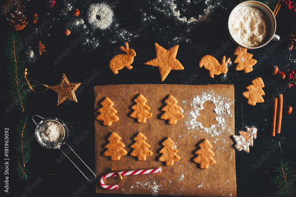 christmas cookies on parchment paper dark background