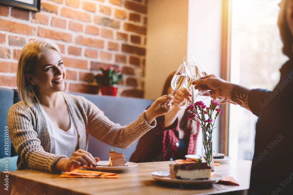 Young woman toasting with friends.