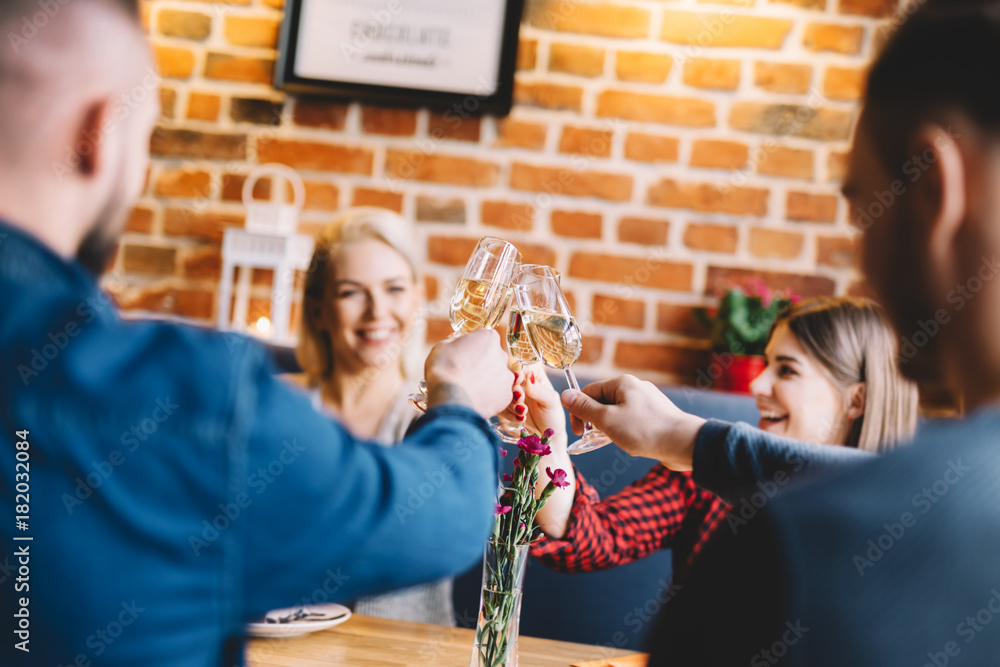 Young people toasting and laughing.