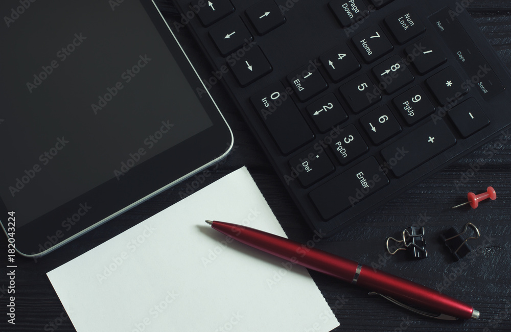 Office supplies with keyboard, tablet pc and pen with blank paper