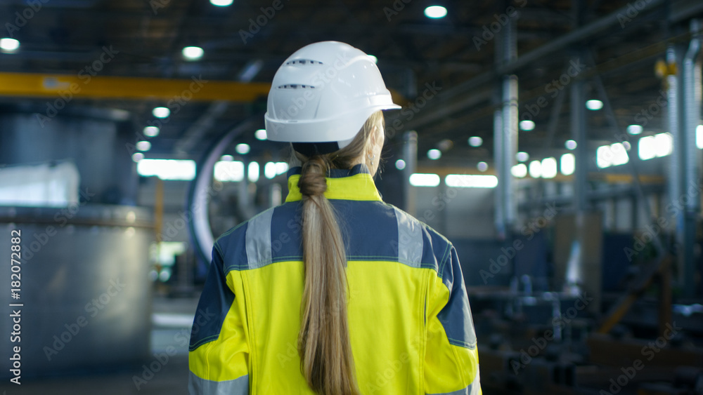 Shot of Female Industrial Worker in the Hard Hat Walking Through Heavy Industry Manufacturing Factor