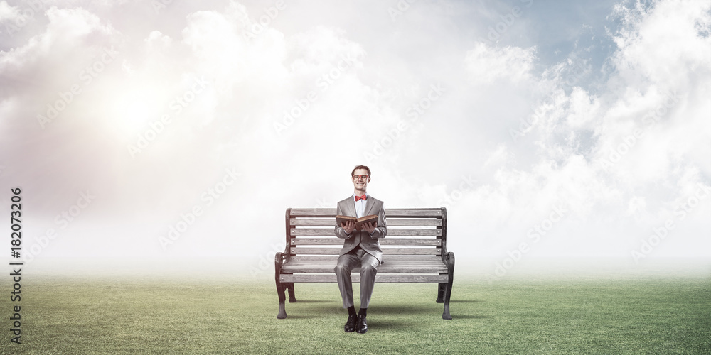 Young businessman or student studying the science in summer park