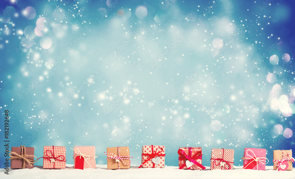 Collection of Christmas gift boxes in a snow covered landscape