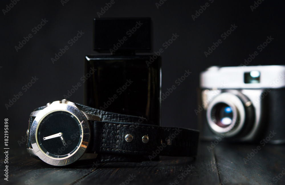 Male watch, vintage camera and perfume