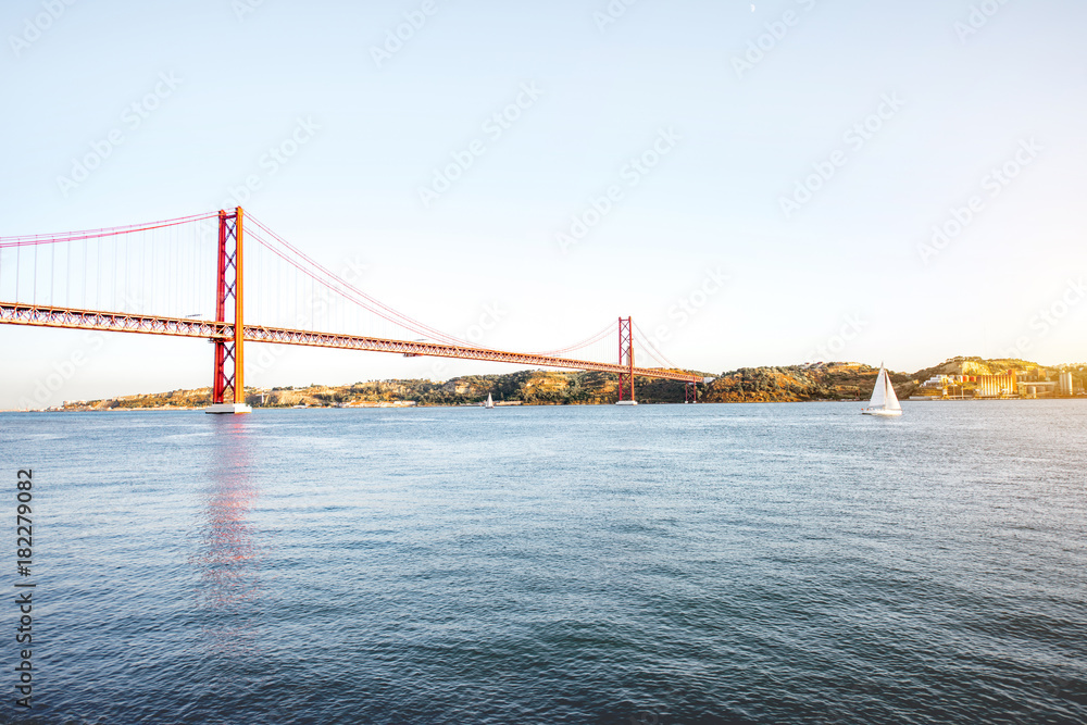 Landscape view on the 25th of April Bridge during the sunset in Lisbon city, Portugal