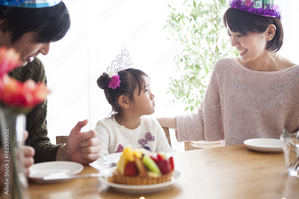 Dad and mommy are celebrating her daughter s birthday.