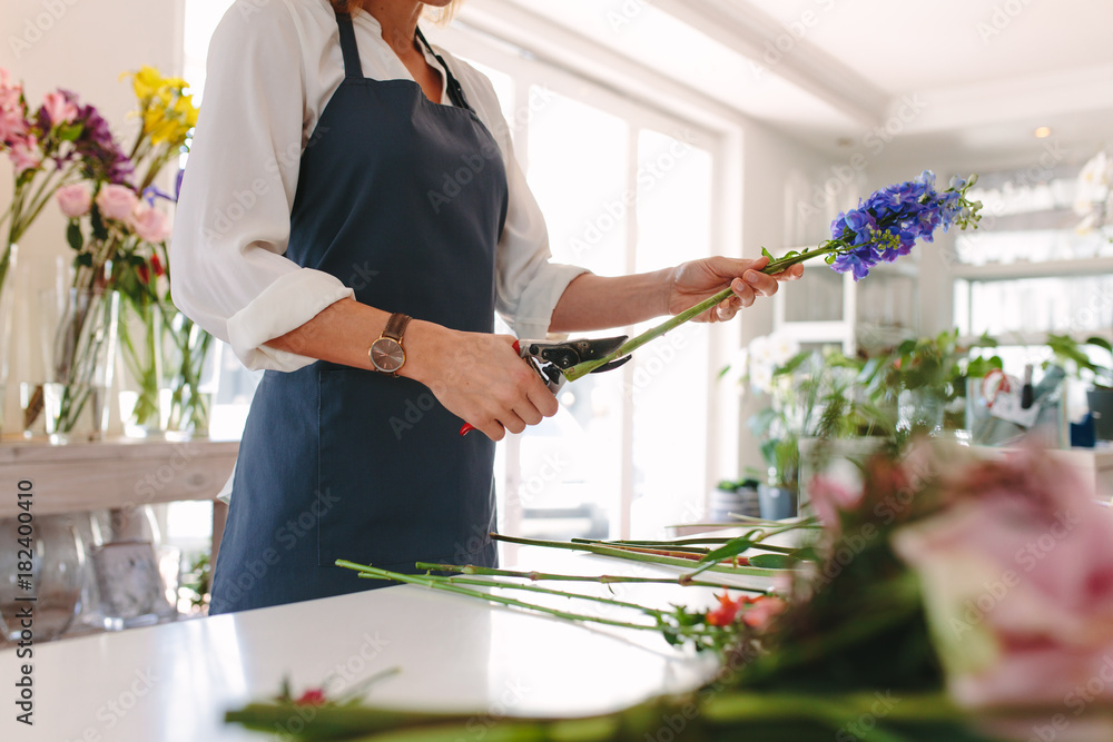 Female florist creating bouquet