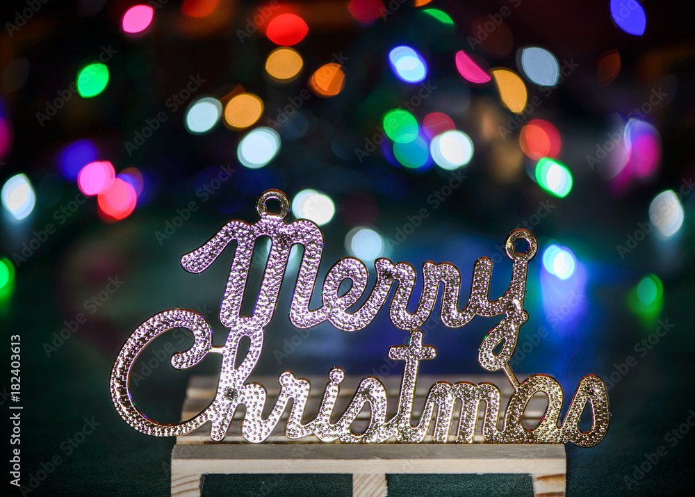 Merry Christmas text decoration with colored light spots

