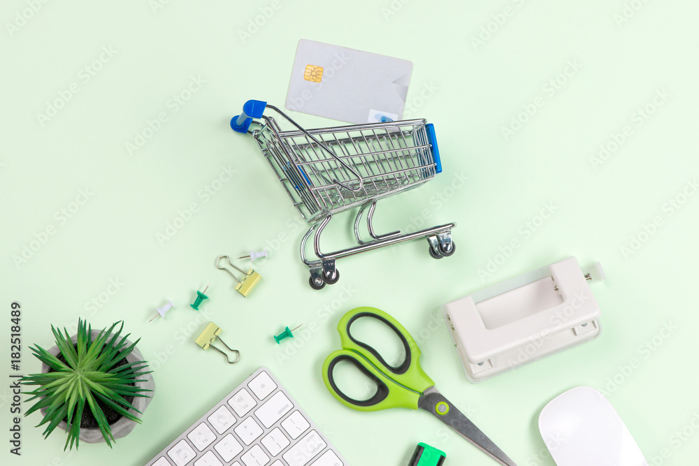 Shopping cart with credit cards on old wood background.