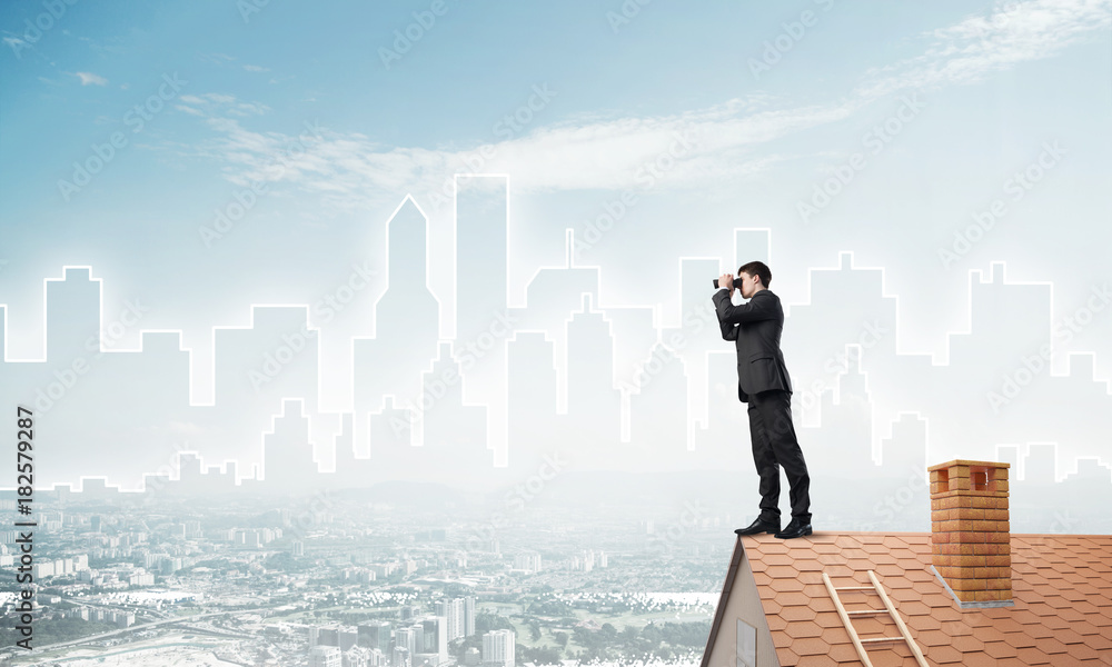 Businessman standing on roof and looking in binoculars. Mixed media