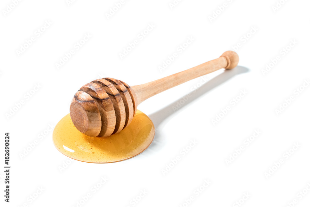 Honey and wooden dipper isolated on white background