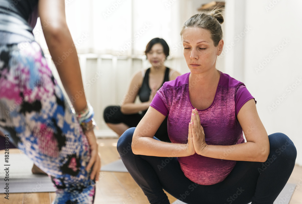 Pregnant woman in yoga class