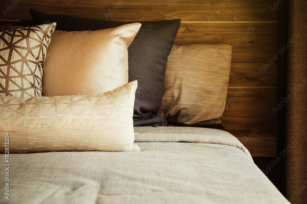 Bed maid-up with clean white pillows and bed sheets in beauty room. Close-up. Lens flair in sunlight