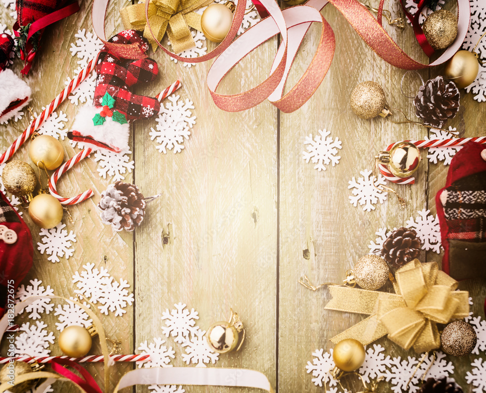 festive background concept with christmas decorating items on wooden background with light filter