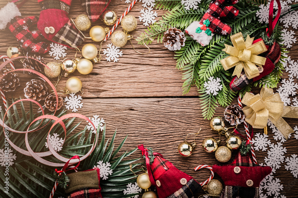 festive background concept with christmas decorating items on wooden background with light filter