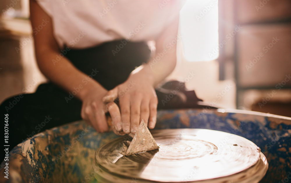 Female potter working on potters wheel