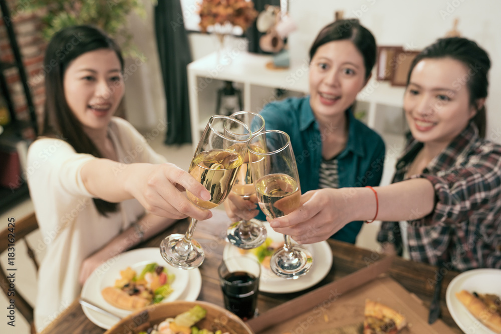 Friends hands toasting champagne glass