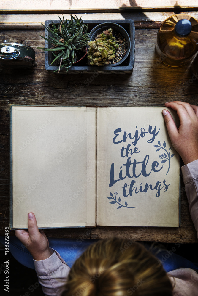 Enjoy little things phrase written on notepad