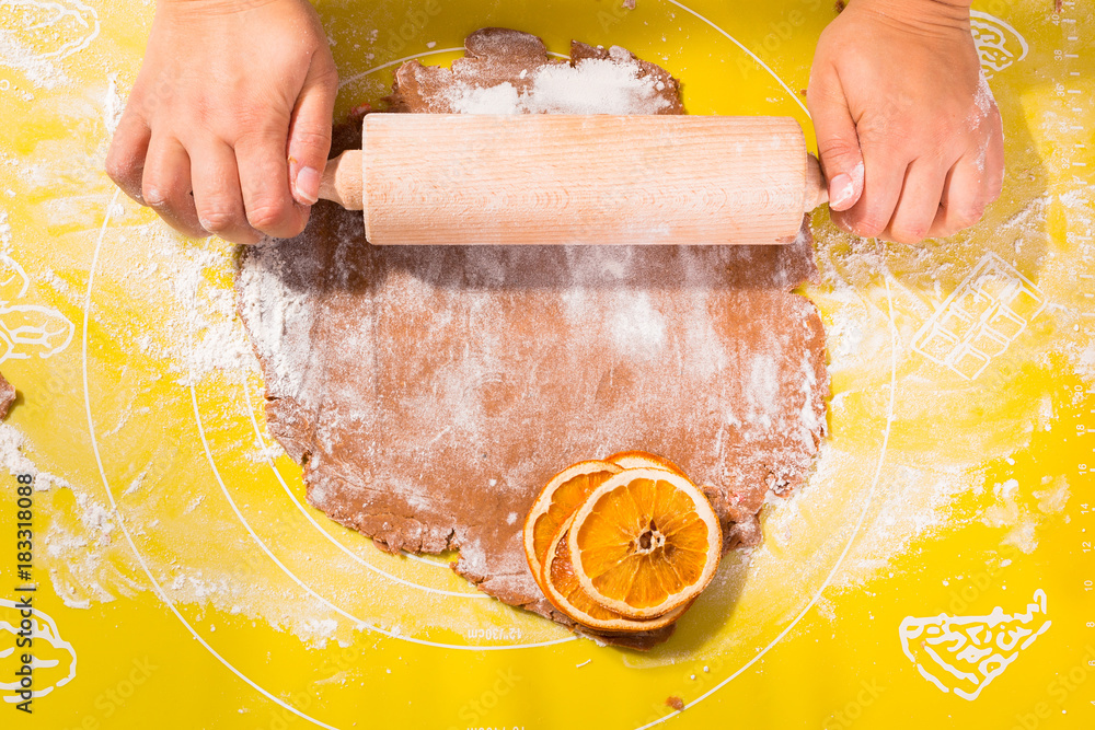 Top view of hands making gingerbread cookies for Christmas.