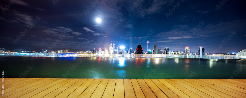 empty wooden floor near pool in modern city